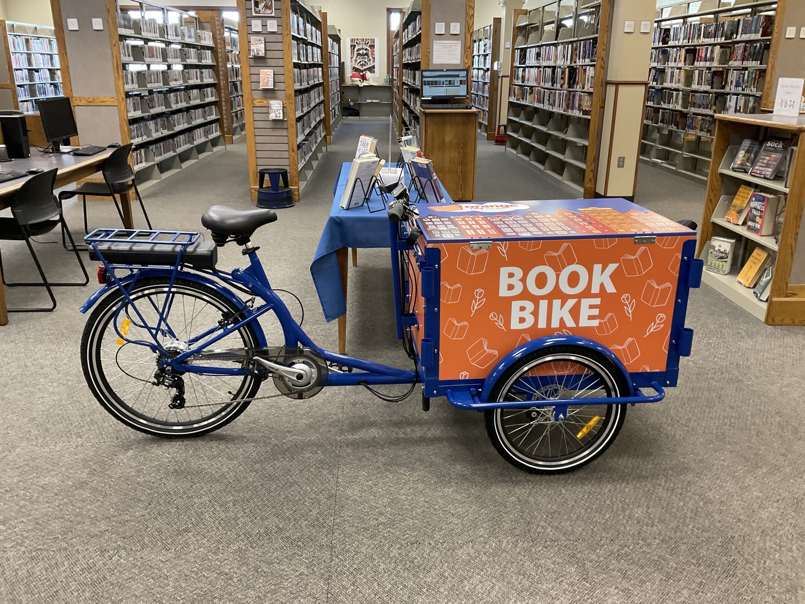 photo of a book bike with orange cargo box in the front